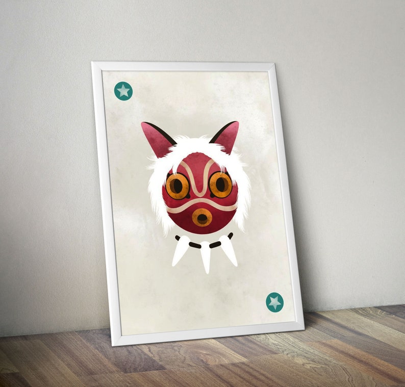 May include: A white framed print featuring a red and white illustration of a mask with a white furry outline. The mask has two large yellow eyes and a small red mouth. There are two teal stars in the corners of the print.