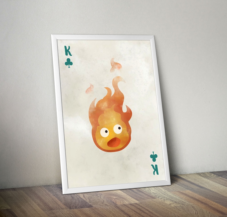 K&ouml;nnte beinhalten: Eine Spielkarte im Vintage-Stil mit einer Aquarell-Illustration eines Feuergeistes aus dem Film "Howls bewegliches Schloss". Die Karte ist der K&ouml;nig der Kreuz und tr&auml;gt die Aufschrift "K" sowie ein Kleeblatt-Symbol in der oberen linken und unteren rechten Ecke.