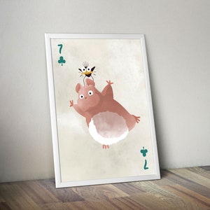 May include: A white framed print of a cartoon illustration of a pink and white creature with a black bird on its head. The print features the number 7 of clubs in the top left corner and the number 7 of clubs in the bottom right corner.