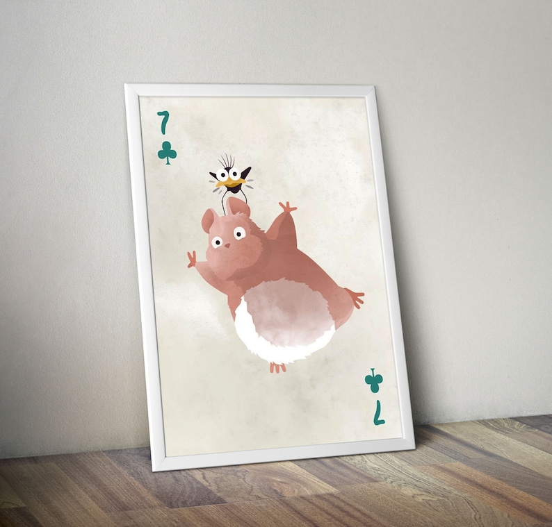 May include: A white framed print of a cartoon illustration of a pink and white creature with a black bird on its head. The print features the number 7 of clubs in the top left corner and the number 7 of clubs in the bottom right corner.
