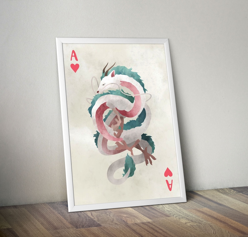 May include: A white and green dragon with pink accents is curled up in a circle. The dragon is on a white card with a red heart and the letter A in the corner. The card is framed in white.