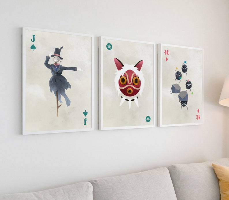 May include: Three framed prints of playing cards featuring characters from the animated film Spirited Away. The first card is the Jack of Spades and features the No Face character. The second card is the Ace of Stars and features the character of the spirit mask. The third card is the 10 of Diamonds and features the soot sprites.