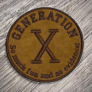 May include: A brown embroidered patch with the text "GENERATION X" in a circle. The text "So much fun and no evidence!" is written in a smaller font below the circle.