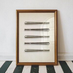 May include: Framed print featuring five vintage baseball bats in a sepia tone. The bats are arranged vertically against a cream-colored background, encased in a wooden frame. The artwork is displayed on a wall with a black and white striped floor.