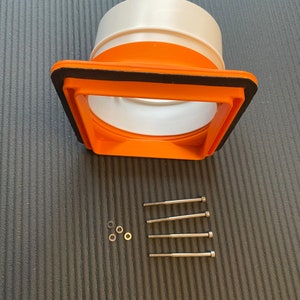 May include: An orange and white plastic fitting with a square opening and a circular end. The fitting has a black gasket around the square opening. Four silver screws and three washers are also included.