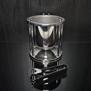 Vintage ice bucket by Guy Degrenne. Beautiful stainless steel design. Signed. Ice tongs included. France, 1980s.