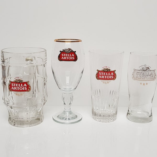 Set of 4 different vintage Stella Artois beer glasses.