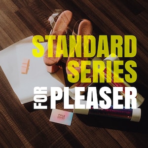 May include: A pair of clear heeled sandals with a pink strap and a yellow text overlay that reads "STANDARD SERIES for PLEASURE".