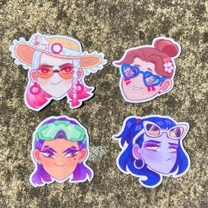 May include: Four colorful cartoon character stickers with different hairstyles and facial expressions. Each character is wearing sunglasses. The stickers are on a gray textured background.