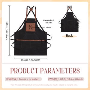 May include: Black canvas apron with brown leather accents, measuring 40.16 inches in height and 25.70 inches in width. Features a front pocket and a leather patch for initials. The back view is also shown.