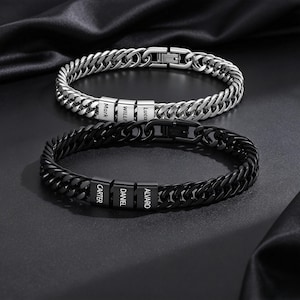 Peut inclure: Deux bracelets à maillons gourmette, l'un argenté et l'autre noir, comportant chacun trois perles rectangulaires gravées de noms. Le bracelet argenté porte les noms Mark, Willi et Luca, tandis que le bracelet noir porte Carter, Daniel et Alvaro.