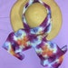 100% silk scarf tie dyed in purples with orange butterfly shaped star bursts