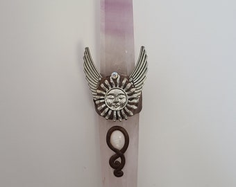 May include: A pink crystal point with silver wings and a sun face charm. The crystal is wrapped with a brown wire and a white pearl.