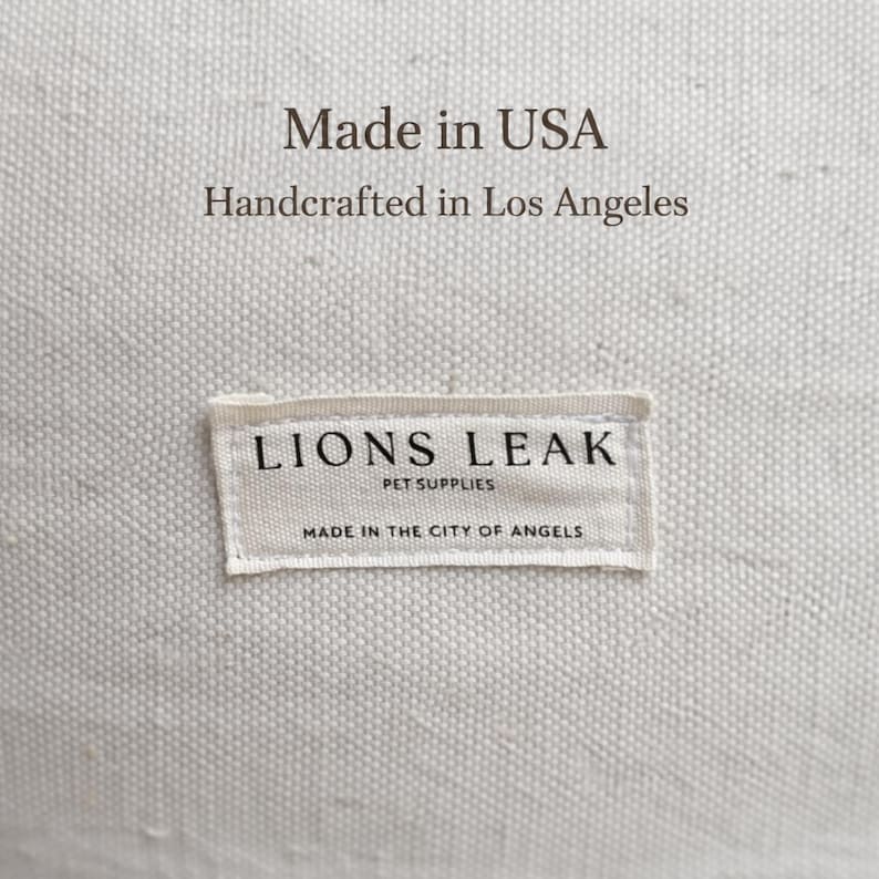 Lions Leak dog bed label close up, made in USA handcrafted pet bed, natural cotton canvas fabric detail, premium handmade dog bed branding tag