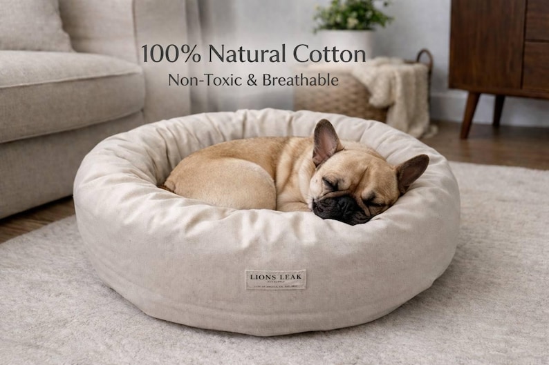 French bulldog sleeping on natural cotton dog bed, cozy donut pet bed in home interior, breathable washable dog bed with removable cover