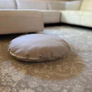 round dog bed cover beige cotton canvas on floor minimalist interior