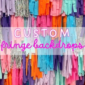 May include: A colorful fringe backdrop with the text "CUSTOM fringe backdrops" in pink lettering.
