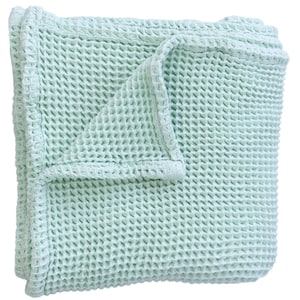May include: A folded, light green waffle-weave blanket. The blanket has a textured surface with a grid-like pattern. The edges are neatly finished with a border. The blanket is made of a soft material.