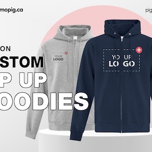 Può includere: Due felpe con zip, una grigia e una blu navy, con la scritta "YOUR LOGO" stampata su ciascuna. La felpa blu navy ha un segno più rosso sul petto.