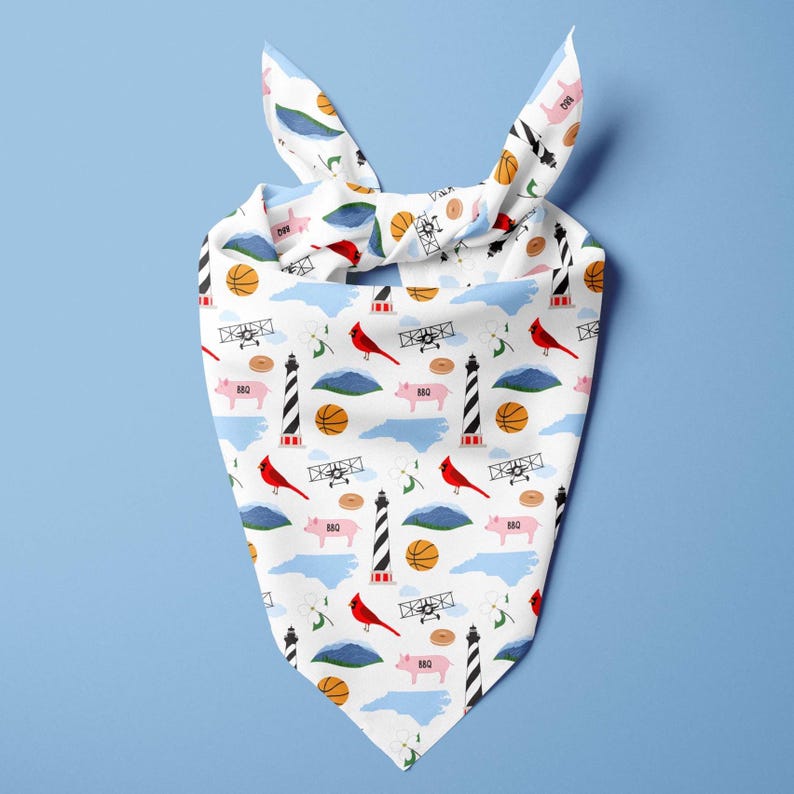 May include: White bandana with a repeating pattern of a basketball, red cardinal, airplane, lighthouse, pig, and mountain. The bandana is tied at the top with two knots.