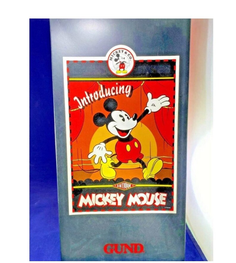 May include: A vintage Mickey Mouse advertisement on a gray background. The image features Mickey Mouse in a red and yellow outfit, with the words "Introducing" and "Mickey Mouse" prominently displayed. The logo "Mickey & Co." is at the top.