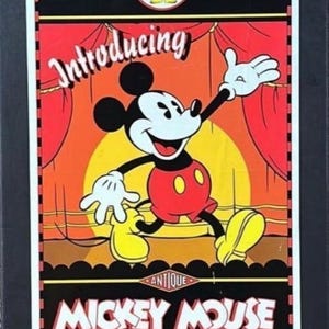 May include: Vintage Mickey Mouse poster featuring Mickey in a red shorts, yellow shoes, and white gloves. The poster has the text "Introducing" and "Antique Mickey Mouse" with the Gund logo at the bottom. The background is a stage setting.