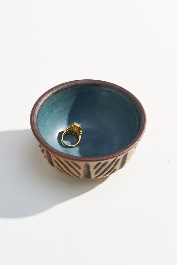 A signed, one-of-a-kind studio pottery bowl with that unmistakable mid-century Scandinavian geometric form and a striking blue interior — the kind of thing you find at an estate sale and brag about forever.