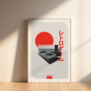Peut inclure: Impression encadrée représentant une console de jeu rétro. L'œuvre comprend un soleil rouge, une console et une manette, avec du texte japonais. La palette de couleurs est composée de rouge, noir, gris et blanc.