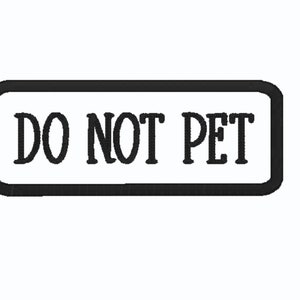 May include: A rectangular patch with a black border and the words "DO NOT PET" in black, centered on a white background. The text is in a bold, sans-serif font.