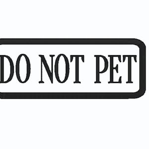 May include: A rectangular sign with a black border and the words "DO NOT PET" in bold, black letters. The sign is set against a white background.