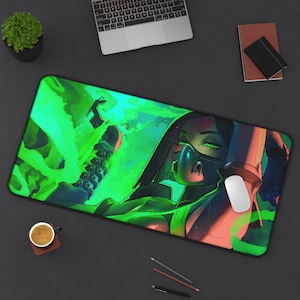 May include: A green and black mousepad with a stylized illustration of a woman wearing a gas mask and a green and black outfit. The woman is surrounded by green flames.