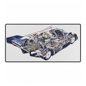 May include: A cutaway illustration of a white and blue Porsche 956 race car. The car is shown with its engine and other internal components visible. The car has the word "MANNS" on the rear wing.