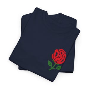 May include: A navy blue t-shirt featuring a graphic of a red rose on the lower right side. The petals of the rose are stylised to form the letters DSA in a bold, red font. The rose includes a green stem and two green leaves at the base.