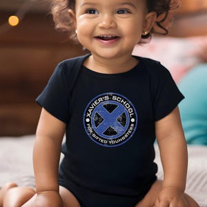 May include: A black baby onesie with a blue and white distressed circle graphic that says "Xavier's School for Gifted Youngsters".