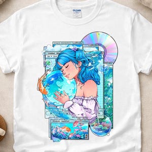 May include: A white short-sleeved t-shirt featuring a graphic print of a person with blue hair holding a glowing blue orb. The design includes computer window elements, koi fish, a compact disc, and text that reads Windows Aquarium.
