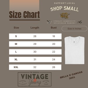 May include: Size chart for a white t-shirt with measurements in inches for bust and length. The chart shows sizes S, M, L, XL, and XXL. The text "Support Local Shop Small" is at the top of the chart. The text "Uphold Community Encourage Makers" is below the chart. The text "Size in Inches" is in a white box with a black border. The text "Bella & Canvas 3001" is at the bottom of the chart.