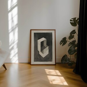 May include: A framed abstract art print with a geometric design in shades of gray and white. The print is set against a dark gray background and is framed in a natural wood frame.