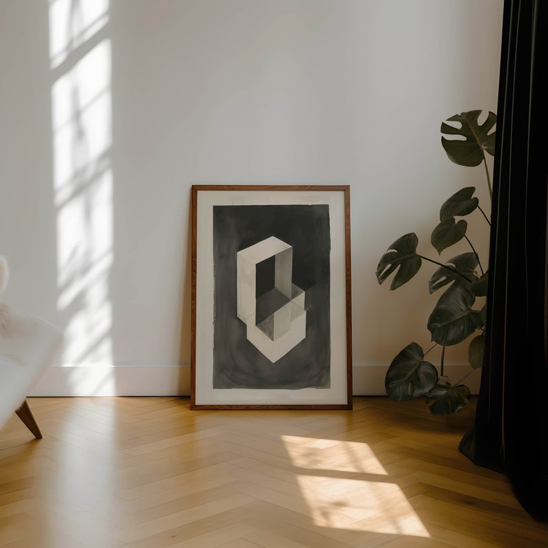 May include: A framed abstract art print with a geometric design in shades of gray and white. The print is set against a dark gray background and is framed in a natural wood frame.