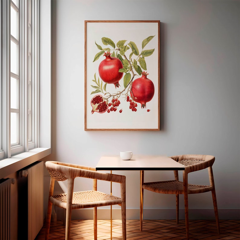 May include: A framed botanical illustration of a pomegranate branch with two red pomegranates and a single open pomegranate with red seeds. The illustration is set against a white background.