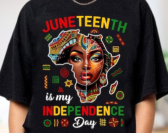 May include: Black t-shirt with a colorful graphic celebrating Juneteenth. The design features a woman's face within the outline of Africa, with the words "Juneteenth is my Independence Day" in vibrant colors.