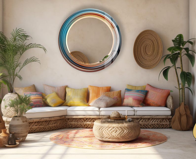 a living room filled with lots of furniture and a round mirror