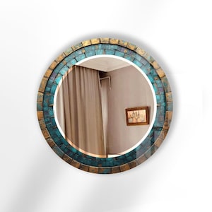 a round mirror with a blue and gold frame