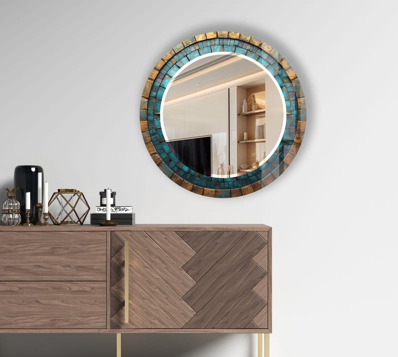 a round mirror on a wall above a dresser