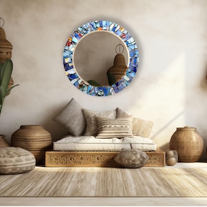 a living room filled with furniture and a round mirror