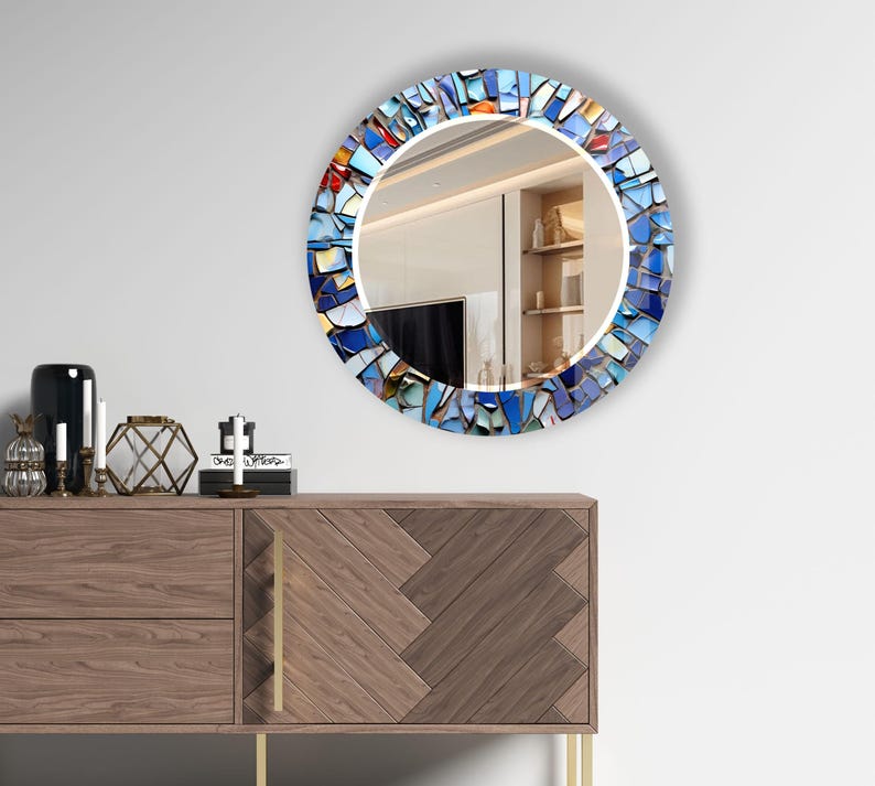 a mirror that is on the wall above a dresser