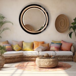 a living room filled with lots of furniture and a round mirror