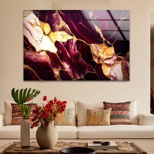 a living room with a white couch and a painting on the wall
