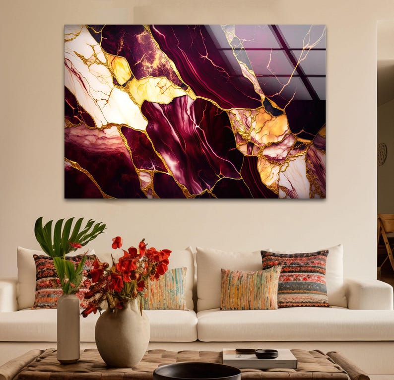 a living room with a white couch and a painting on the wall