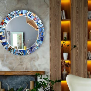 a living room with a fireplace and a mirror on the wall