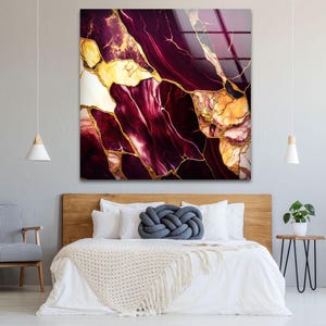 a bedroom with a bed and a painting on the wall